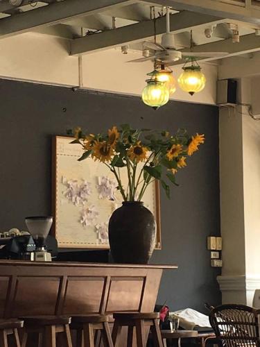 a vase of flowers sitting on top of a table at Villa Duangchampa in Chiang Mai