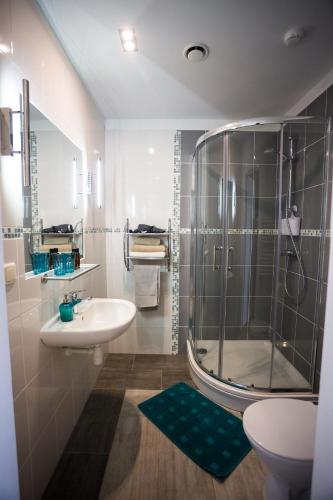 a bathroom with a shower and a sink and a toilet at Irbēni in Brivkalni