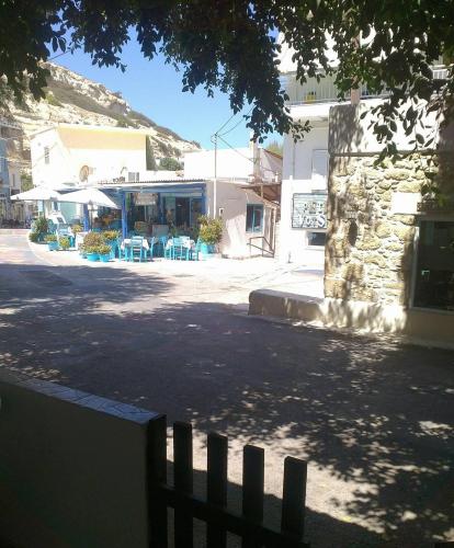 a fence in front of a street with a building at Polymnia's apartment in Matala