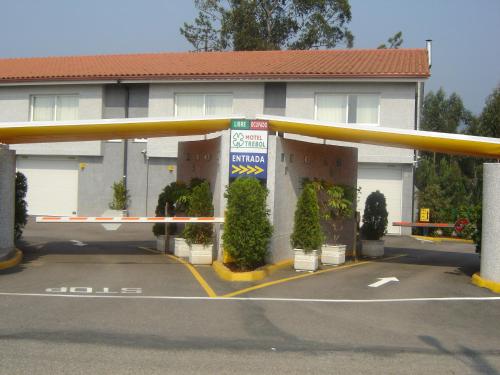 a parking lot in front of a building at Motel Trebol in Tui