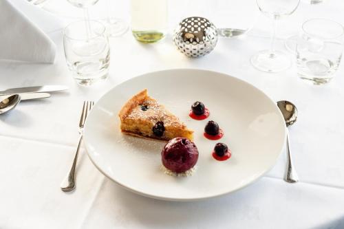 a white plate with a piece of food on a table at Mullion Cove Hotel & Spa in Mullion