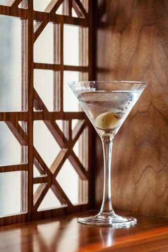 a martini glass sitting on top of a wooden table at Mullion Cove Hotel & Spa in Mullion