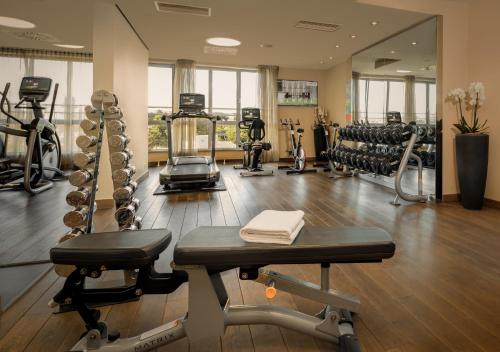 a gym with treadmills and machines in a room at Lindner Hotel Vienna Am Belvedere, part of JdV by Hyatt in Vienna