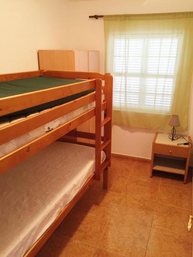 two bunk beds in a room with a window at Casa Bonita in Abades