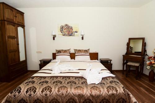 a bedroom with a large bed in a room at Guesthouse Nefertiti in Smolyan