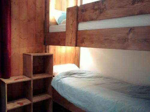 a bedroom with two bunk beds and a mirror at Chalets D'Or, Les Deux Alpes in Mont-de-Lans
