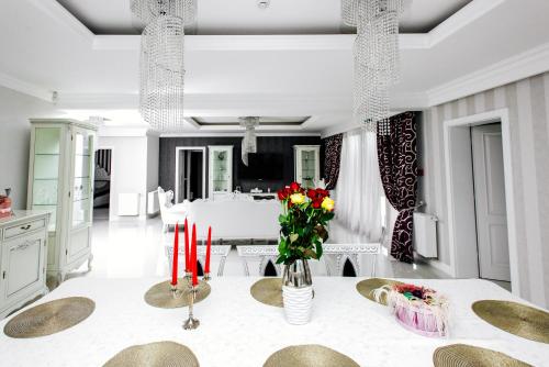 a dining room with a table with red candles at Pensiunea Primaverii in Satu Mare