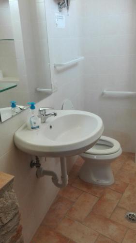 a bathroom with a white sink and a toilet at Agriturismo Cerquaglia in Todi