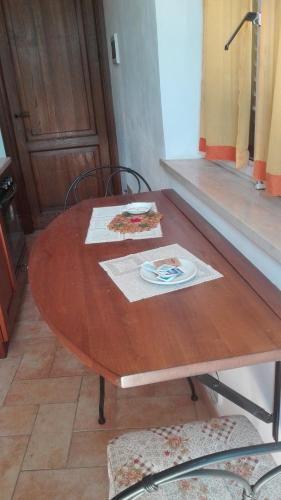a wooden table with a plate of food on it at Agriturismo Cerquaglia in Todi
