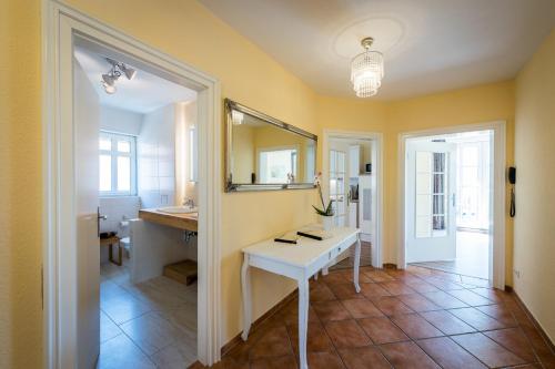 a bathroom with a white sink and a mirror at Bellevue Ferienwohnungen in Quedlinburg