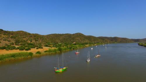 a group of boats floating in a river at Golden Club Cabanas in Cabanas de Tavira