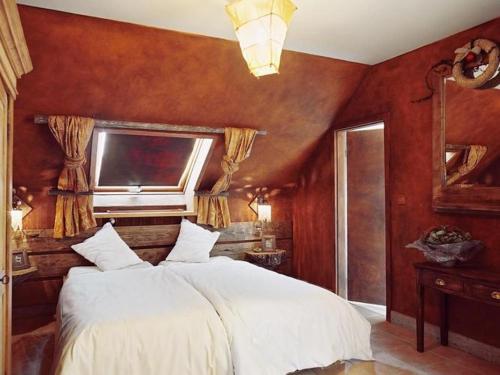 a bedroom with a white bed and a window at Holiday Home in Vielsalm with Garden in Vielsalm