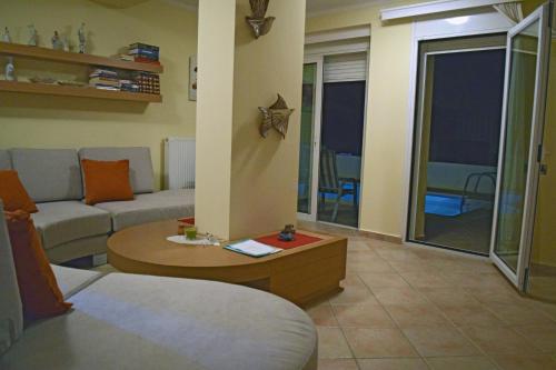 a living room with a couch and a table at Private pool & Panorama View on Athens center Hill in Athens