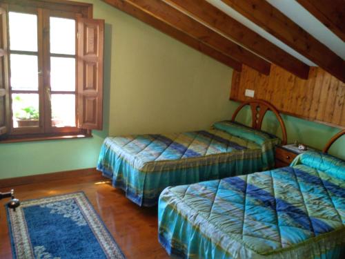 a bedroom with two beds and two windows at Callejon de la Vega in Ríocaliente