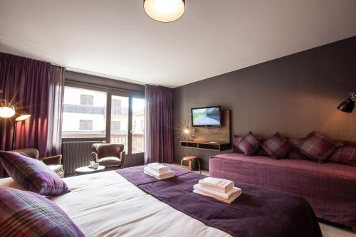 a hotel room with a bed and a couch at Pointe Isabelle in Chamonix-Mont-Blanc