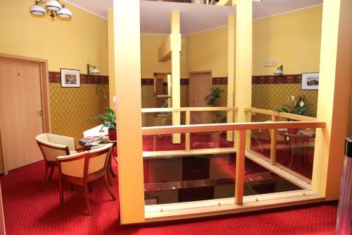 a room with a balcony with a table and a dining room at Willa West Ende in Szczecin