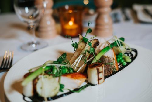 a plate of food on a table with a glass at Spa Hotel at Ribby Hall Village in Wrea Green