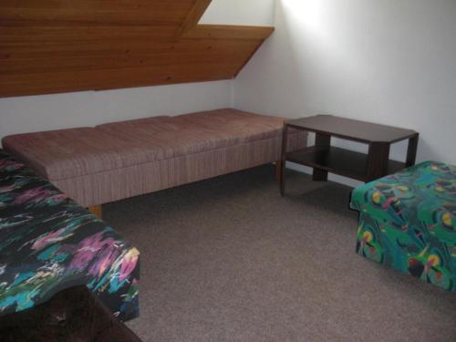 a room with a bed and a table in it at Horský Ranč in Pec pod Sněžkou