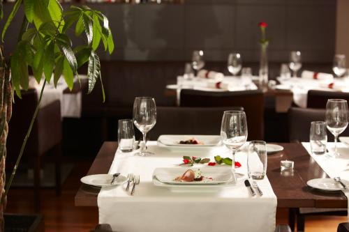 a table in a restaurant with plates of food at Hotel Restaurant Rössli in Bad Ragaz