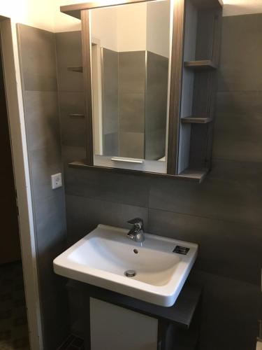 a bathroom with a white sink and a mirror at Appartment Stepanek in Saalbach Hinterglemm