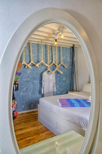 a mirror reflecting a bedroom with a bed in a room at Lindos Tholos Villa in Lindos
