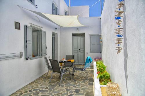 a small balcony with a table and chairs in a building at Lindos Tholos Villa in Líndos