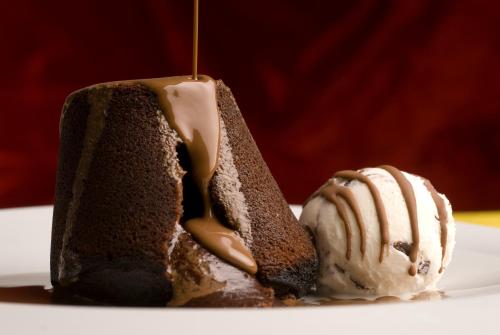 a piece of chocolate cake with ice cream on a plate at Boutique Hotel Astoria in Kotor