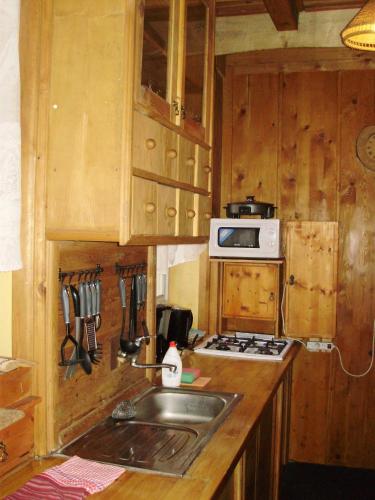 a kitchen with a sink and a stove top oven at Pension nad Truhlárnou in Svoboda nad Úpou