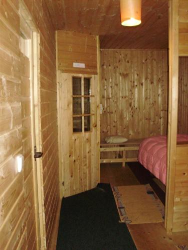 a room with a bed in a wooden cabin at Pension nad Truhlárnou in Svoboda nad Úpou