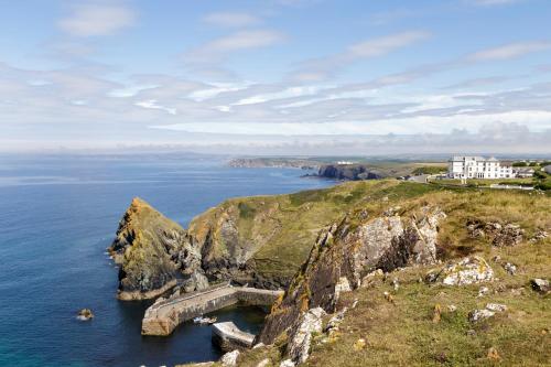 an aerial view of a cliff with the ocean at Mullion Cove Hotel & Spa in Mullion