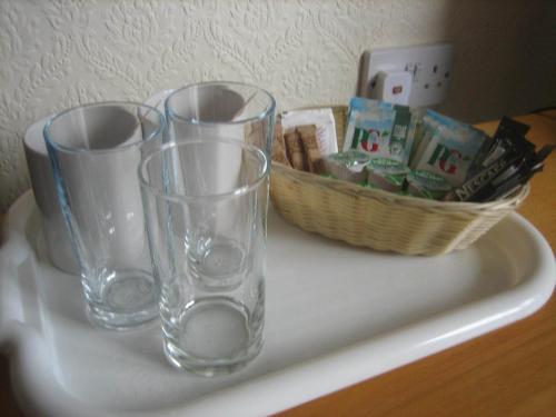 three glass vases sitting on a counter with a basket at Murrayfield Park Guest House in Edinburgh