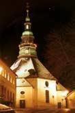a tall building with a clock tower at night at Landhotel zu Heidelberg in Seiffen