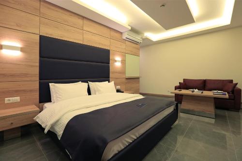 a bedroom with a large bed and a desk at Ibiza Hotel in Jounieh