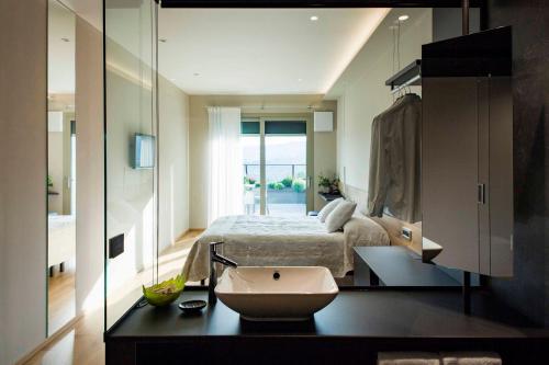 a bathroom with a bed and a sink in a room at Hotel Ristorante La Rosina in Marostica