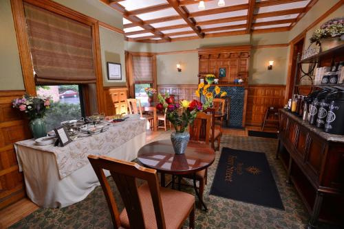 a dining room with a table with flowers on it at The Inn on Ferry Street in Detroit