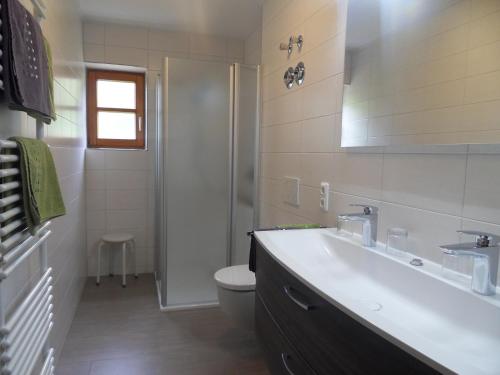 a bathroom with a sink and a toilet and a shower at Ferienhof am Mitterberg in Bad Birnbach