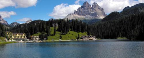 a large lake in front of a mountain at Ka' Tari in Ponte nellʼAlpi