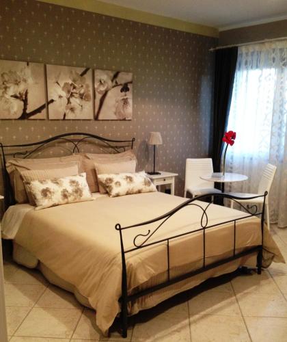 a bedroom with a large bed with polka dot wallpaper at Cherry House Bed&Breakfast in Campobasso