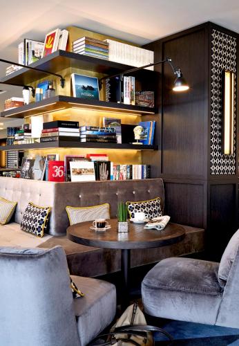 a living room with a table and two chairs at Seaside Park Hotel Leipzig in Leipzig