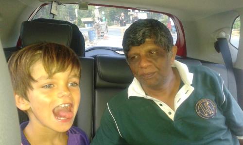 a man and a young boy sitting in a car at Peacock Residence & Cabana's in Tangalle