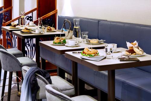 a row of tables with plates of food on them at Seaside Park Hotel Leipzig in Leipzig