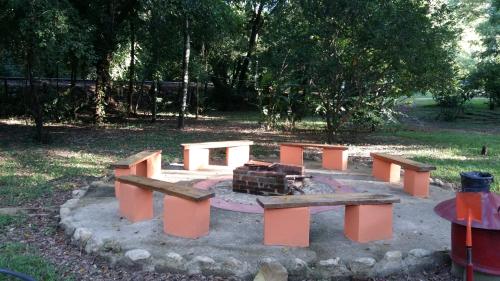 a group of picnic tables in a park at Cabañas Kin Balam Palenque in Palenque