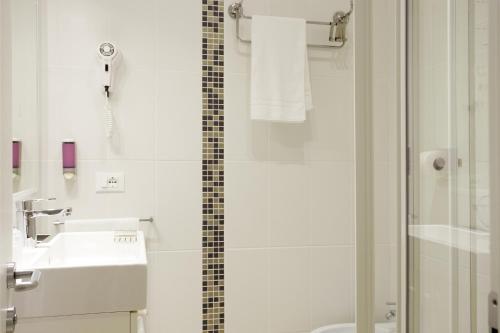 a bathroom with a shower and a sink and a toilet at Hotel Speranza in Lido di Jesolo