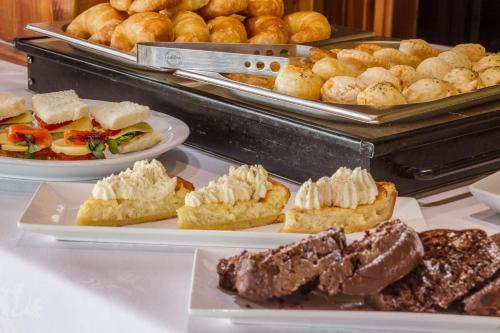 a variety of pastries are displayed on a table at Charming Luxury Lodge & Private Spa in San Carlos de Bariloche
