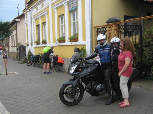 a man and a woman standing next to a motorcycle at Base for Adventurers - Urban Guerrilla in Negotin