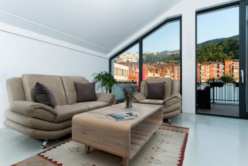 a living room with a couch and a coffee table at BA Apartments in Sarajevo