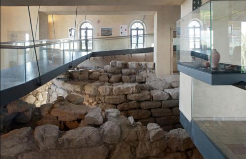 a museum with a large rock floor in a room at B&B Casa Piras IUN3880 in Barùmini