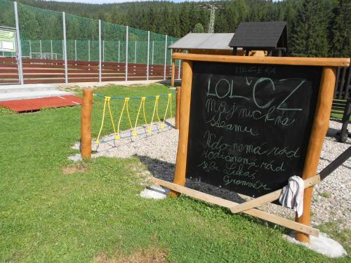 a chalkboard sign with writing on it in the grass at Pension Martinské údolí - dependance in Kořenov