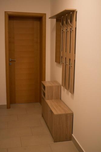 a room with a wooden door and a stairway at Motel Aura in Mostar