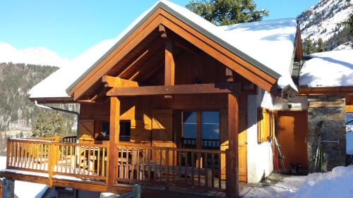 a log cabin with snow on the roof at Clos du Pre - Chalet Chaleur in Oz